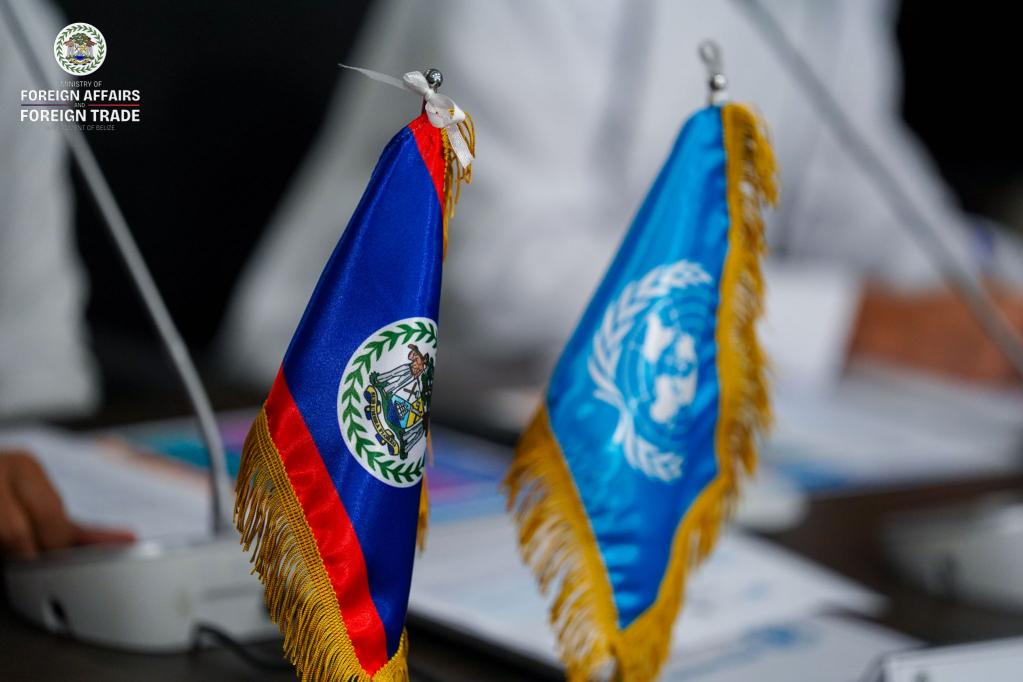 Close up photo of the desk flags of the United Nations and Belize