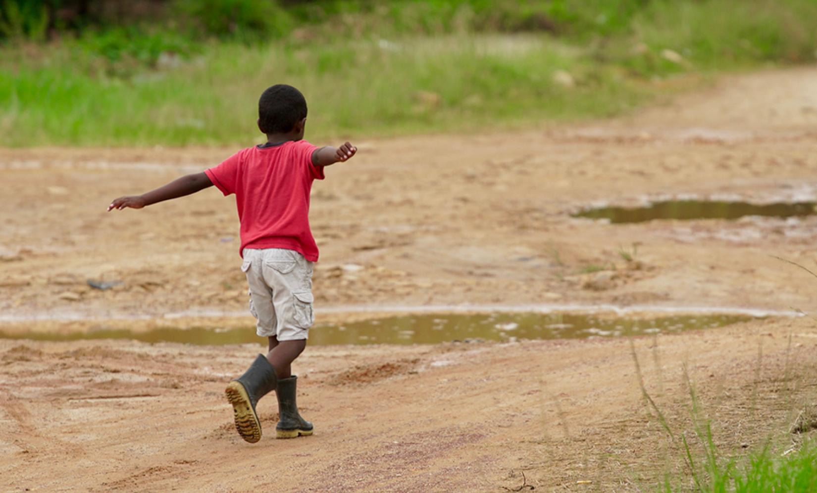 A young boy navigates puddles in Hopkins.