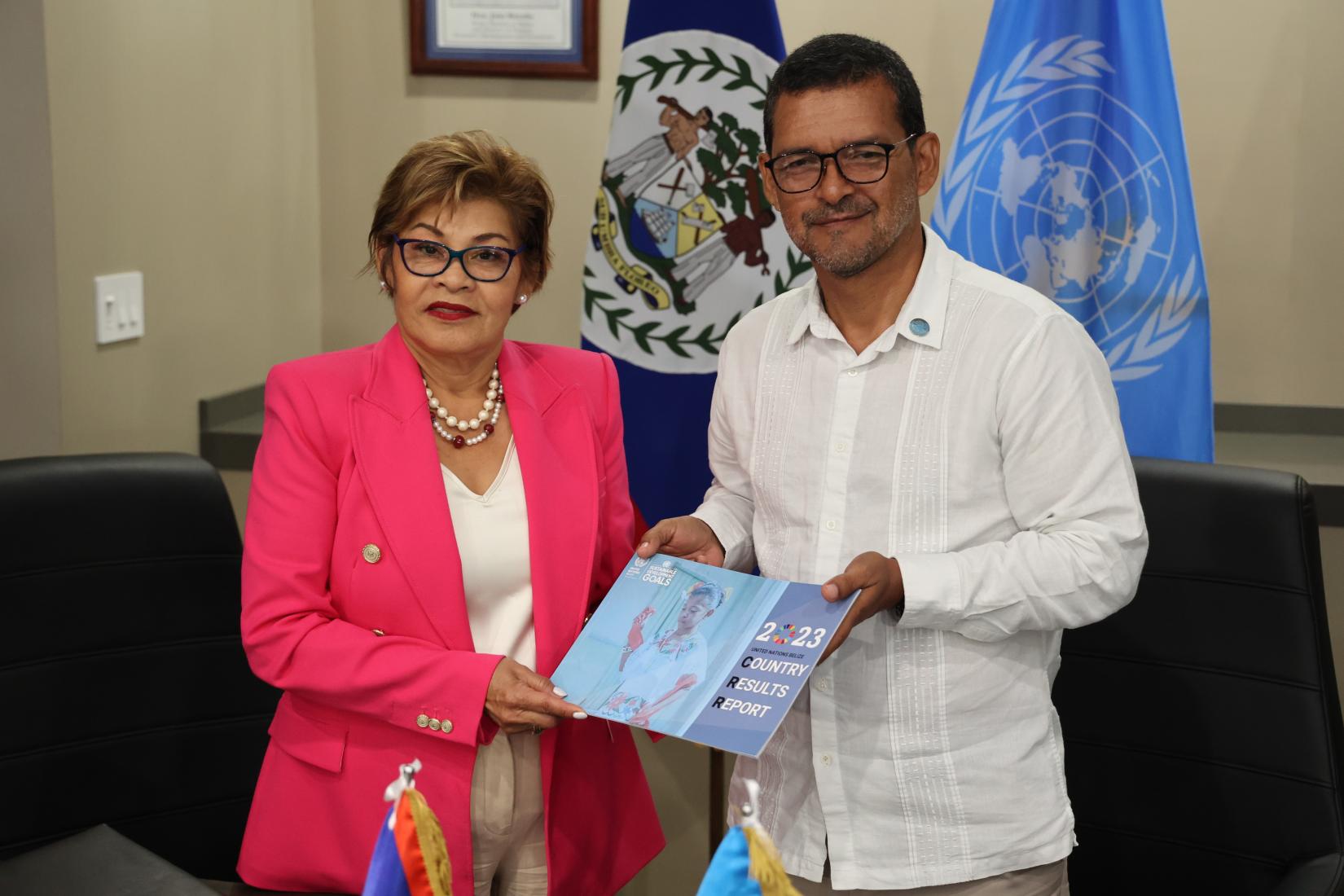 Woman and man stand next to each other holding a document