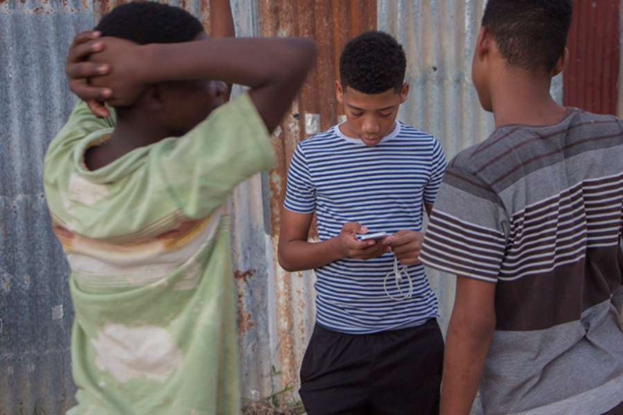 Kaydeon (standing in the center) doesn't feel safe playing outdoors. He's much more comfortable playing with his gadgets indoors.