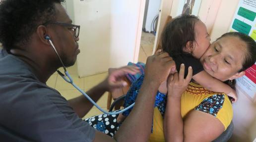 Dr. Jaheel Elijio as he cares for one of his patient at the Santa Theresa Clinic