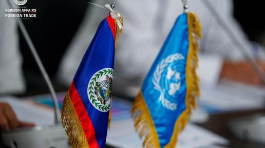 Close up photo of the desk flags of the United Nations and Belize